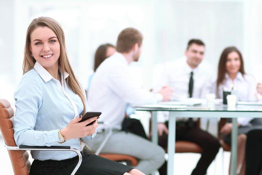 young employee with a smartphone on the background of business team.