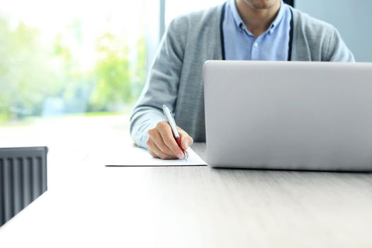 Businessman hands pointing at business document. Closeup.