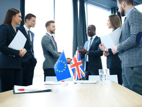 European Union and United Kingdom leaders shaking hands on a deal agreement.