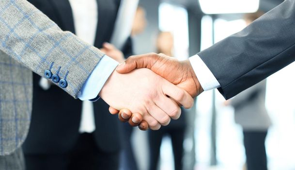 Close up of the businessmen shaking hands.