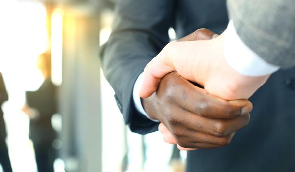 Close up of the businessmen shaking hands.