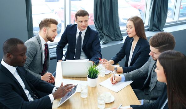 Business team discussing together business plans in office