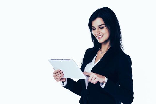 Young, attractive, successful business woman studying a business plan on the tablet on a white background