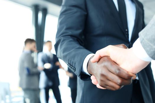 Close up of the businessmen shaking hands.