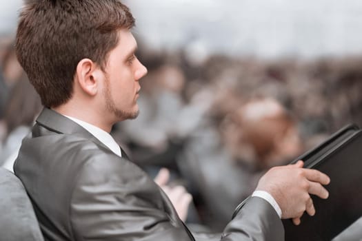 close up. businessman sitting in the hall at a business conference. business and education