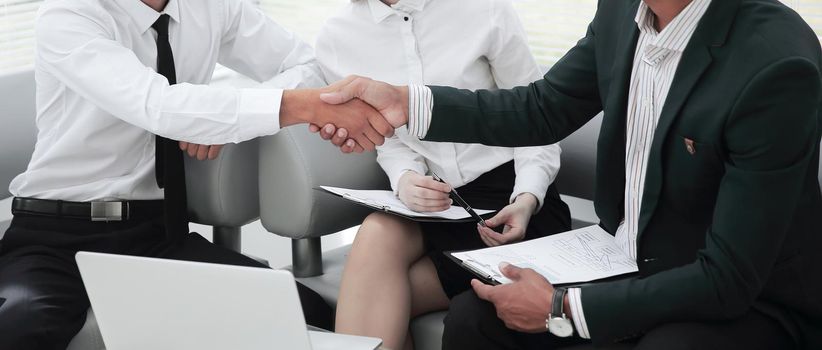 closeup .the Manager confirms the transaction with the client.business handshake