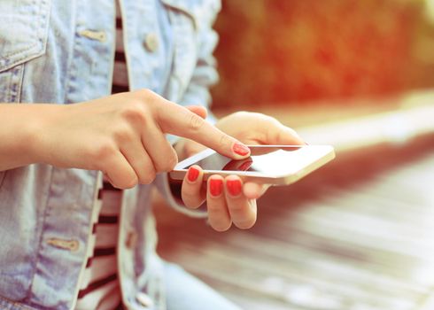 Close up of a woman using mobile smart phone