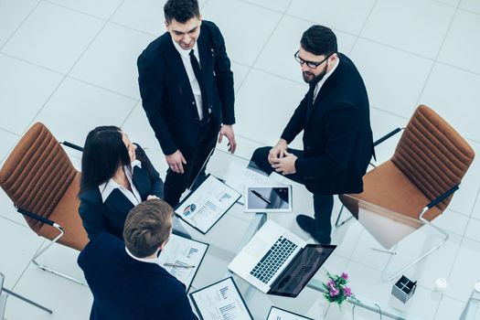 top view of successful business team discussing marketing graphics at the workshop meeting in a modern office .the photo has a empty space for your text.