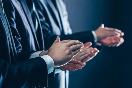 closeup of business team applauding business partners after signing the contract.photo on a black background and has space for your text.