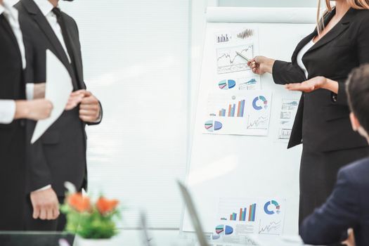 close up. business woman making a presentation to his business team.