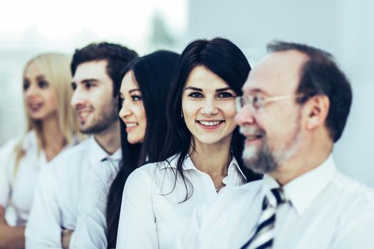 closeup of a professional business team standing next to each other .the photo has a empty space for your text