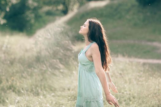 charming girl exposing her face to the fresh wind . photo with copy space