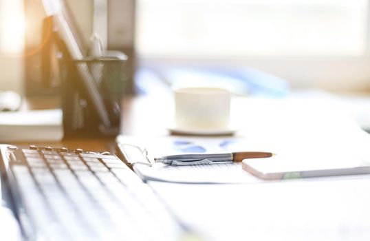 Office supplies and coffee cup on table