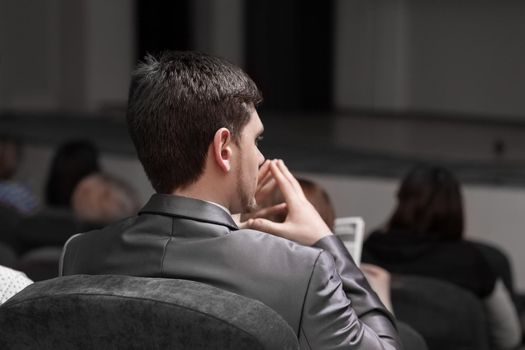 close up.attentive businessman sitting in the conference hall. business and education