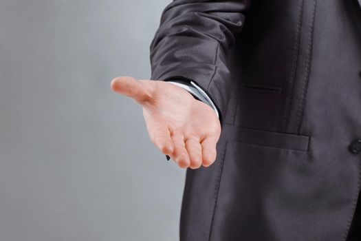 close up. the businessman reaches out to the partner .isolated on grey background.