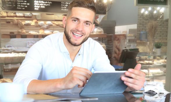 Small business owner working at his cafe