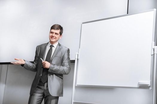 confident businessman standing on stage in the conference hall . business and education