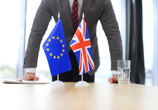 British flag and flag of European Union with businessman near by. Brexit