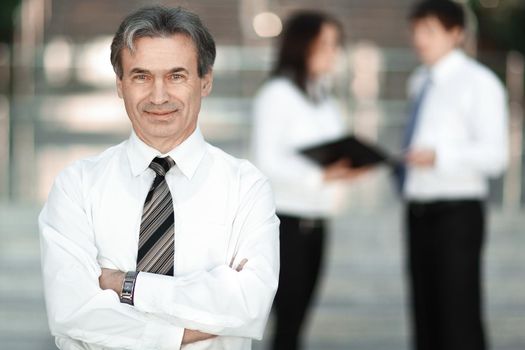 portrait of a senior businessman on blurred background office.photo with copy space