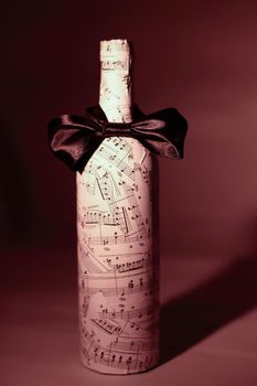 closeup.festively decorated bottle of wine.isolated on a dark background.photo with copy space