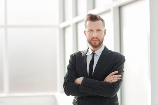 successful businessman on the background of a bright office. photo with copy space