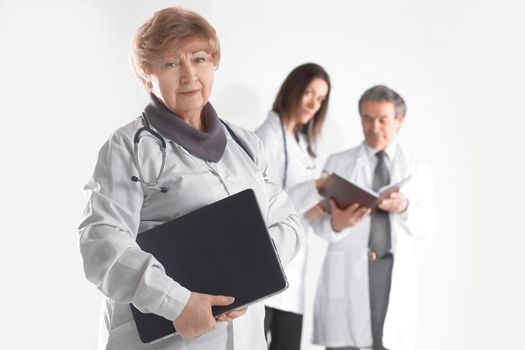 female doctor therapist with laptop on blurred background of colleagues.