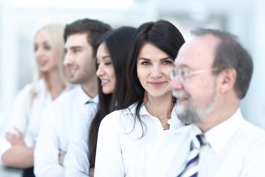 Close-up portrait of executive business people standing in a row at office and looking at the camera. Business persons.