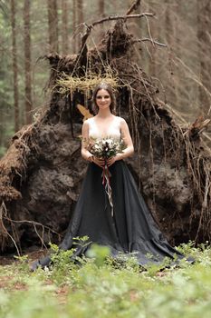 beautiful young woman with bouquet on background of the forest.