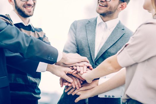 friendly business team standing in a circle and joining his hands together