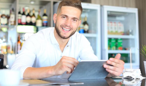 Small business owner working at his cafe