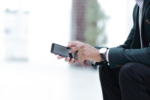 closeup. employee typing SMS on the smartphone.photo with copy space