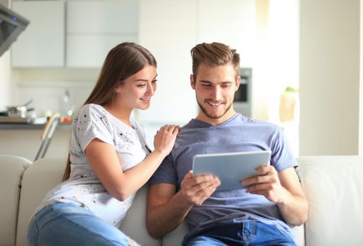 Happy couple in love surfing on tablet at home