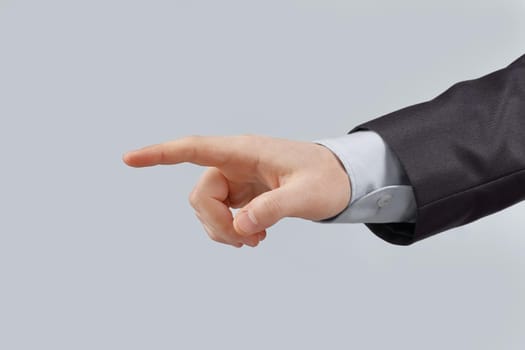 close up. hand of a businessman pointing at a copy space.isolated on grey background.
