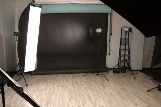 Empty photo Studio with a variety of lighting equipment. photo with copy space