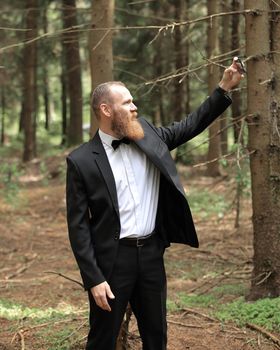 modern businessman taking a selfie in a pine forest.