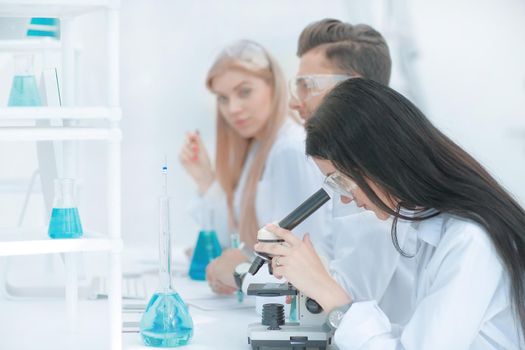 female scientist uses a microscope in the laboratory. science and health