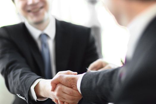 background image close-up of handshake of business partners. the concept of partnership