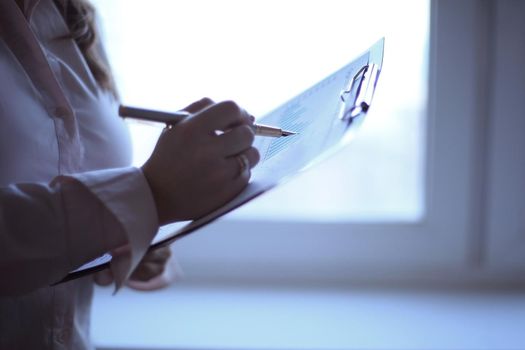 close up. business woman checking financial data.photo with copy space