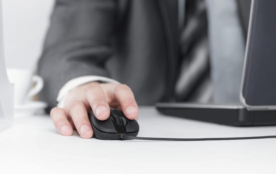 closeup.businessman working on laptop,sitting at his Desk.isolated on white background