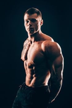 muscular male bodybuilder looking at the camera.isolated on black background