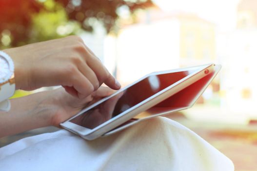 Woman using digital tablet PC in the park