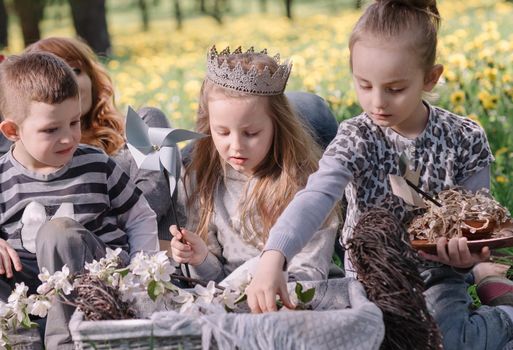 family with children on a picnic on a warm spring day. family holiday concept