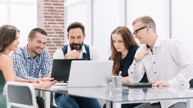 business team discusses new ideas sitting at the office Desk. office weekdays