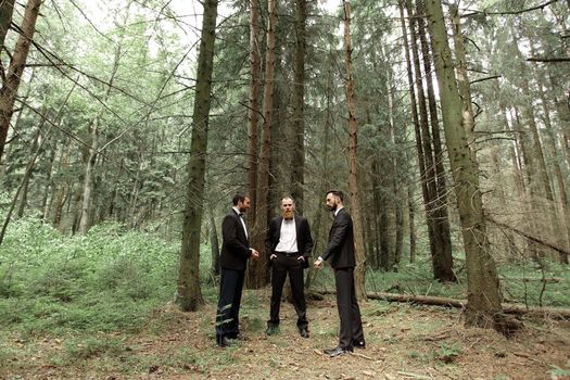 three business partners in the woods.Eco friendly and sustainable business.