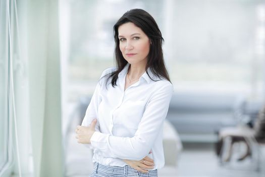 closeup.serious business woman standing near the window in the office.