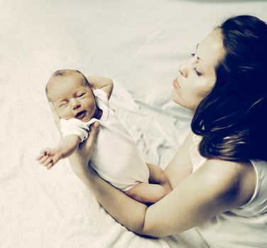 portrait of a young mother with a newborn baby.the photo has a space for your text