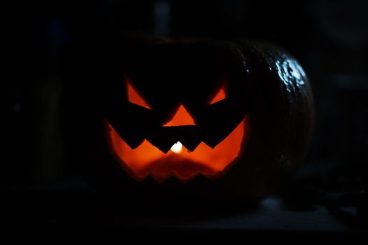 creepy smiling pumpkin for Halloween on black background.photo with copy space