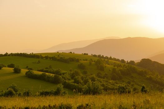 landscape of  summer nature in sunset in mountains and hills on countryside abstract lines and curves background