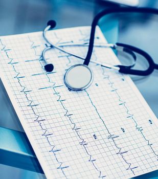 stethoscope and electrocardiogram on the table from the therapist.the photo is a blank space for your text