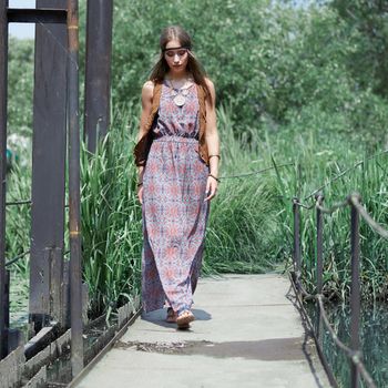 beautiful hippie girl walking on a wooden bridge in the Park . the concept of unity with nature